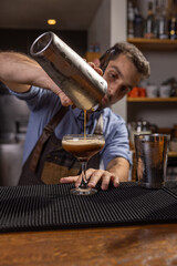 Bartender pouring espresso martini