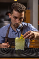 Bartender garnishing a cocktail with kiwano
