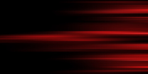 The effect of red light in fast motion on a black background. blurred abstract background with long exposure. neon light
