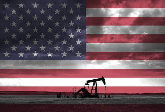 Drilling for oil in the countryside with American national flag overlay
