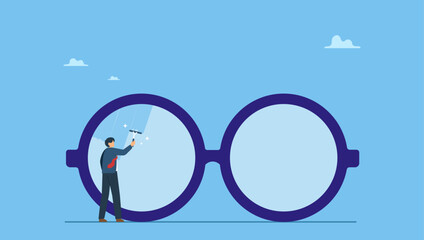 Businessman cleaning huge eyeglass lenses for owner to get clear vision. Clear business vision, see through lenses in details or clean and clear business outlook.