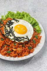 Kimchi bokkeumbap (kimchi fried rice) is a Korean dish consisting of rice fried with kimchi.