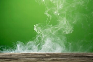 Wisps of white smoke rising from a wooden surface against a green background