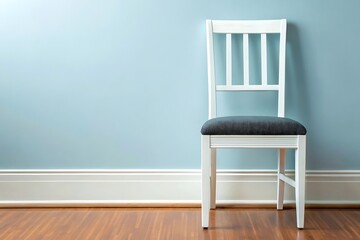 Single white wooden chair against a soft blue wall
