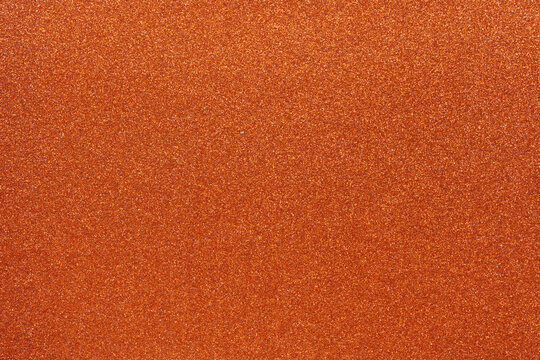 Colorful orange glitter background for holiday design textures