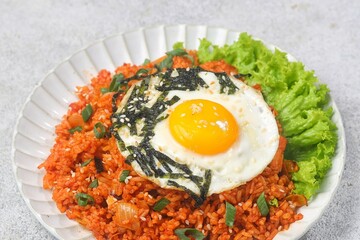 Kimchi bokkeumbap (kimchi fried rice) is a Korean dish consisting of rice fried with kimchi.