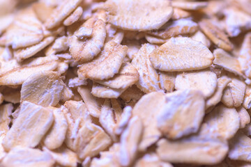 close up of dry rolled oats, ideal for texture, fiber, and healthy grain backgrounds. Perfect for nutrition, plant based diet, and cereal packaging