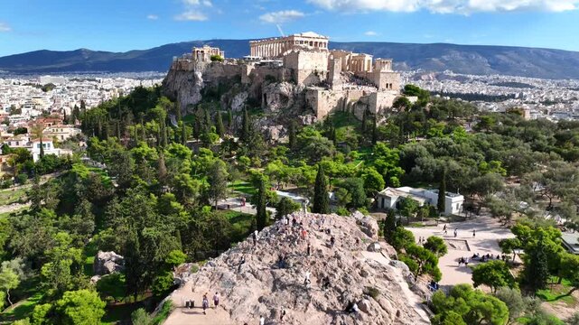 Aerial drone cinematic video of iconic Acropolis hill and the Parthenon featuring Erechtheion and Porch of the Caryatids, Athens historic centre, Attica, Greece