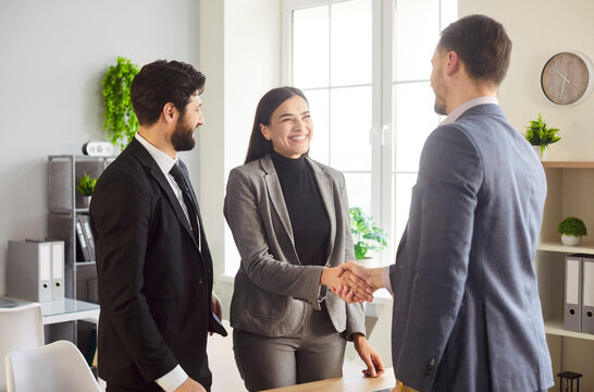 Business partners handshake team in modern office meet to deal, agree, successful employees planning together meeting in workspace, enjoy team work, collaborative task agreement or arrangement 