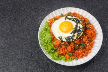 Kimchi bokkeumbap (kimchi fried rice) is a Korean dish consisting of rice fried with kimchi.