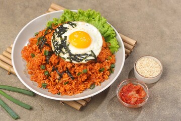 Kimchi bokkeumbap (kimchi fried rice) is a Korean dish consisting of rice fried with kimchi.