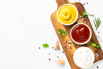 Sauce bowls - mayonnaise, mustard, ketchup on white background.