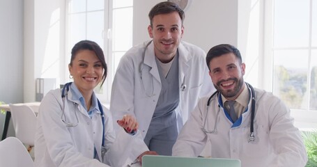 Group portrait of happy doctors and nurses working together using a laptop during team meeting in a hospital. Highlighting teamwork, professional collaboration, and a positive work environment. - Powered by Adobe