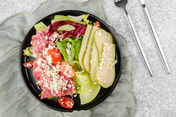 Healthy pear blue cheese salad on gray