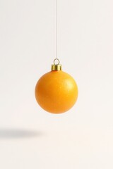 Creative Christmas ball made from orange peel texture, hanging with a gold cap - playful blend of natural fruit and festive ornament