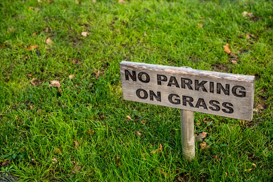 Respect concept background. No parking on grass wooden sign on lawn. Keeping streets beautiful and neat. No transgress or break boundaries, respecting rules and no full access concept. Green grass. - Powered by Adobe