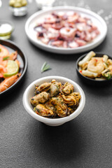 Mussels in white bowl with herbs for seafood menu or healthy lifestyle concept