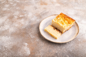 Сottage cheese Сasserole, Curd cake, with dried apricots and raisins on brown concrete, side view, copy space