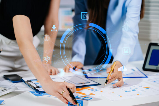 Close up view of UI developer team brainstorming on their project with laptop, smartphone and digital tablet. Creative digital development agency.