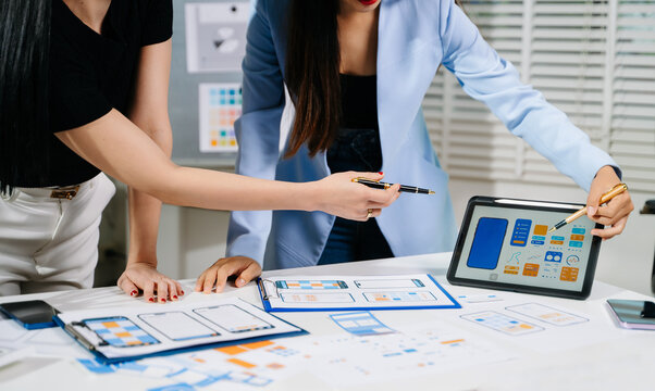 UX graphic designer planning application process development prototype wireframe for web smart phone. Creative digital development agency.