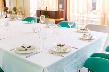 Elegant dining setup with decorative tableware at sunlit restaurant