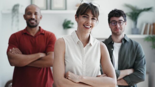 Video of casual business people looking at camera while working in the coworking place