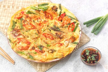 Pajeon is a typical Korean savory pancake made from flour dough, spring onions, and various seafood.