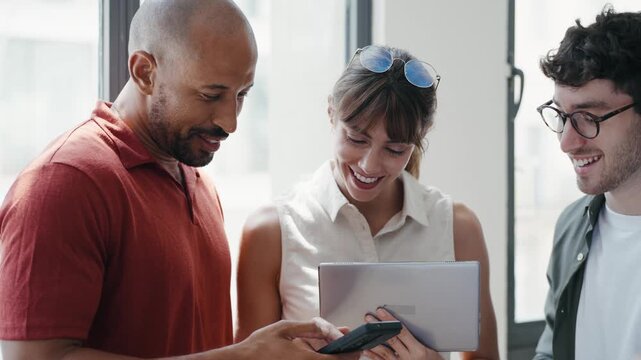 Video of happy business people working with digital tablet while discussing together in the coworking place