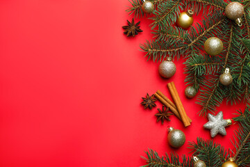 Fir tree branches, spices and Christmas decor on red background, flat lay. Space for text