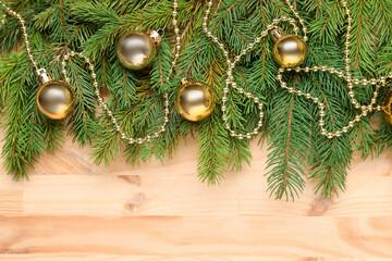 Christmas tree branches with festive decor on wooden table, flat lay. Space for text