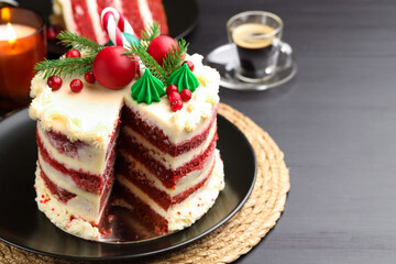 Tasty cake with Christmas decor on black table, closeup