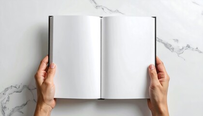 Top-down shot shows open book on a marble surface. Two hands hold pages, blank and ready for use. Aesthetic composition