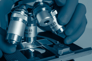 Researcher using microscope for biological analysis in modern science lab