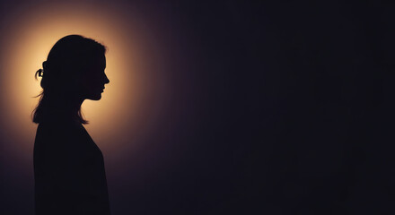 Silhouette of woman against soft, glowing background creates serene atmosphere