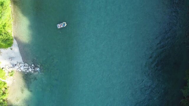 Drone footage in zenithal view of people enjoying in inflatable boats and swimming. Aar river, Switzerland