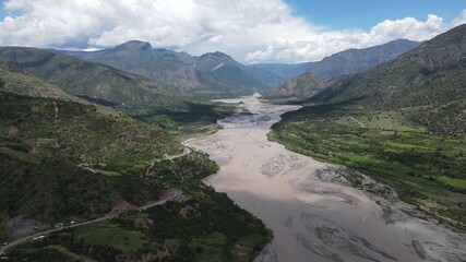 Epic aerial footage of a giant, powerful river snaking through the dense, untouched jungle. Perfect for nature documentaries, travel vlogs, or dramatic film sequences. The scale is breathtaking