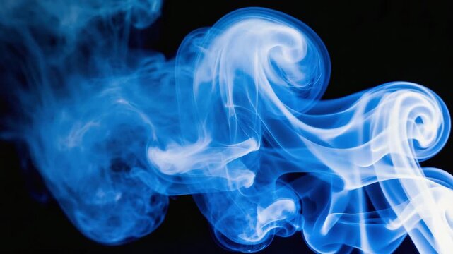 Colorful blue smoke swirling in the darkness