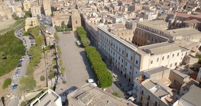 Aerial view of Piazza Scandallato, located in the historic center of Sciacca, in the province of Agrigento, Sicily, Italy. The tree-lined square overlooks the Mediterranean Sea.
