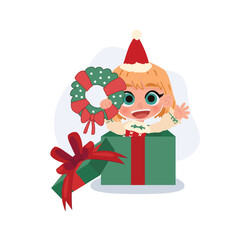 cute blonde girl wearing a santa hat holds a christmas wreath while popping out of a green gift box with red ribbon