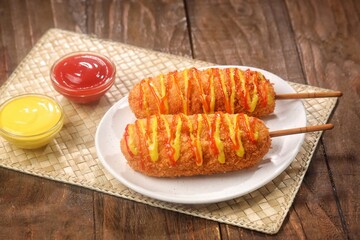 Corndog is a food made from skewered sausages (usually hot dogs) coated in a thick layer of cornmeal and fried.