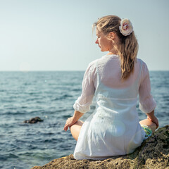 Woman meditating at the sea