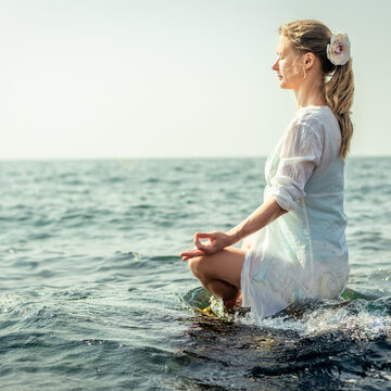 Woman meditating at the sea
