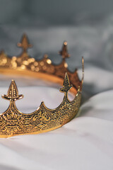 King's crown on white silk closeup