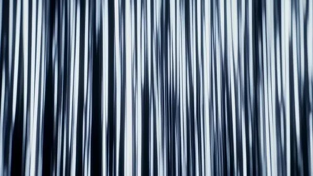 Abstract image of vertical, parallel, blurred lines in grayscale tones, creating a flowing appearance