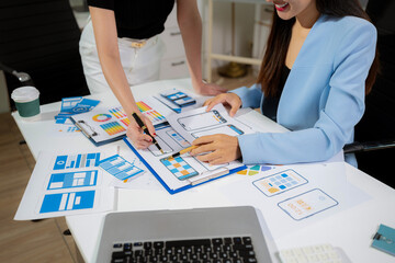 Creative digital development agency. developer team brainstorming on their project with laptop, smartphone and digital tablet.