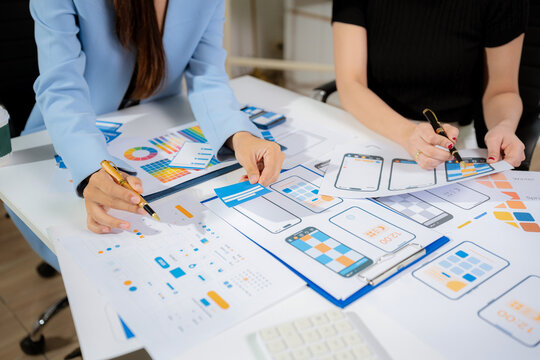 Creative digital development agency. developer team brainstorming on their project with laptop, smartphone and digital tablet.