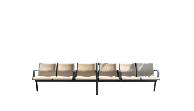 A row of connected, individual seats sit under a dark sky, shadowed. The seats have metal frames and cream-colored cushions