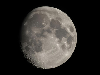 Detailed closeup of full moon surface showing craters and texture against dark night sky in high resolution astronomy image