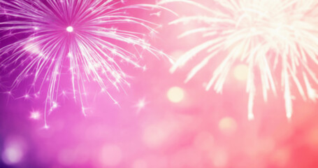 Bright fireworks on abstract defocused pink background