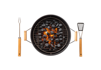 Round black grill with cooking utensils fork and spatula positioned beside burning coals, isolated on a transparent background